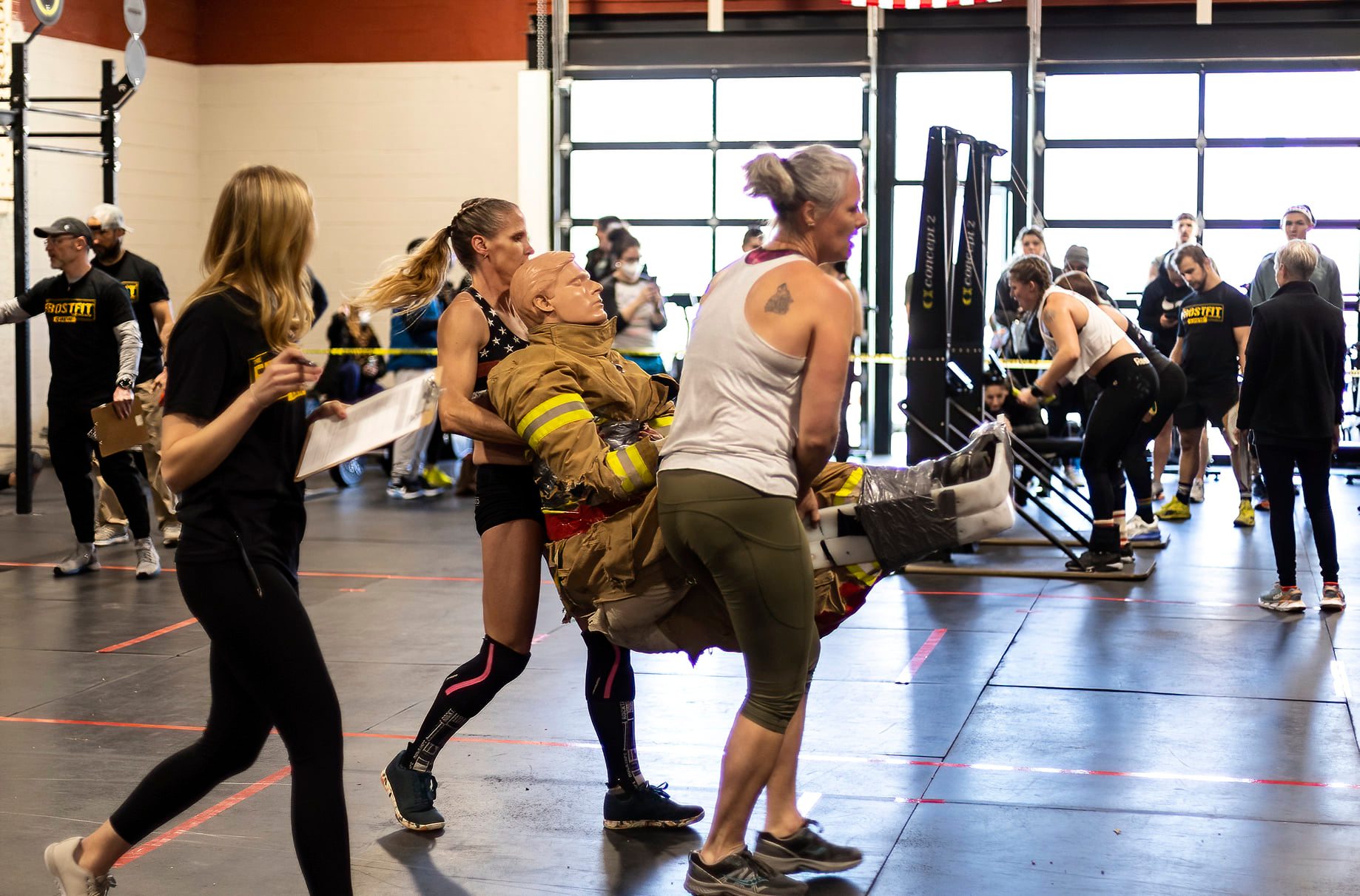 carrying firefighter dummy at crossfit competition www.crossfitmomm.com